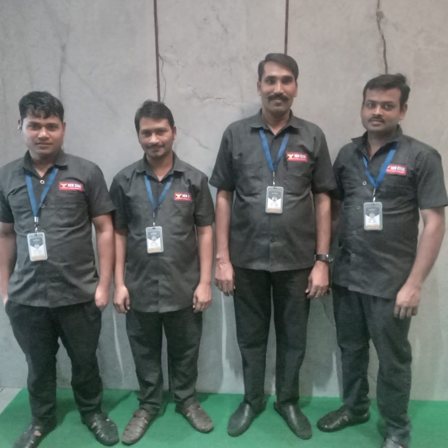 Four uniformed New Edge Security guards on duty